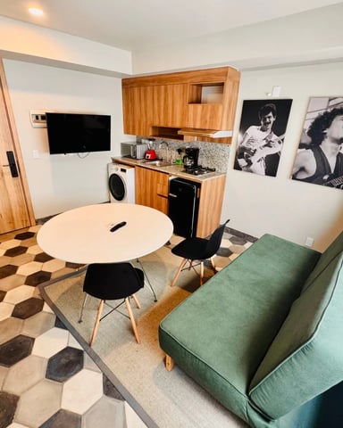 Furnished studio apartment with hexagonal tile floors and musician wall art