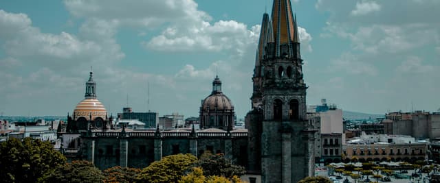 Guadalajara Cathedral towers and colonial domes rising above the city's historic centre under a blue sky