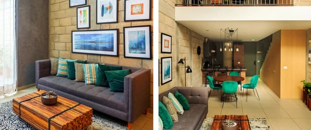 Modern loft living room with exposed brick walls, gray sofa, wooden coffee table, framed artwork, and mezzanine level above